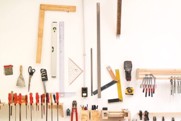 assorted hand tools on white table